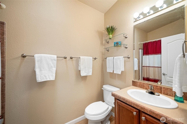 2570 Island View Ln, Lummi Island, WA 98262 - full bathroom featuring toilet, vanity, a shower with curtain, vaulted ceiling, and baseboards