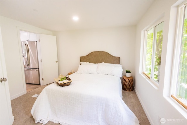 3333 228th St Unit 42, Bothell, WA 98021 - bedroom with stainless steel refrigerator with ice dispenser, light carpet, and multiple windows