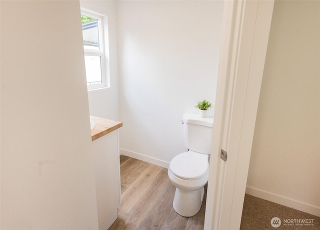 3333 228th St Unit 42, Bothell, WA 98021 - bathroom with vanity, toilet, wood finished floors, and baseboards