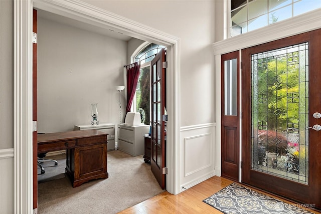 12153 SE 307th Pl, Auburn, WA 98092 - entryway featuring light wood-type flooring, a decorative wall, and a wainscoted wall