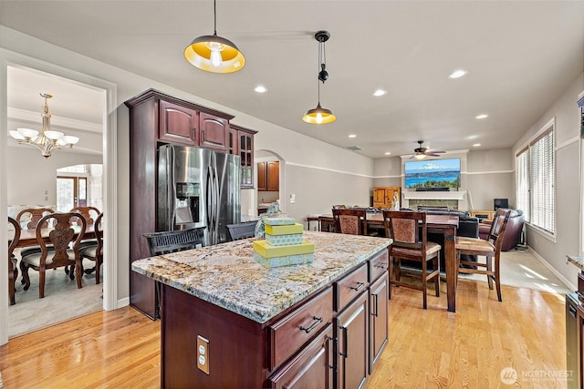 12153 SE 307th Pl, Auburn, WA 98092 - kitchen featuring stainless steel refrigerator with ice dispenser, ceiling fan, light wood-style floors, a center island, and decorative light fixtures