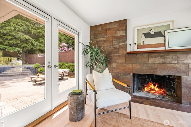 1309 NW Norcross Way, Seattle, WA 98177 - sitting room with a tile fireplace, french doors, and wood finished floors