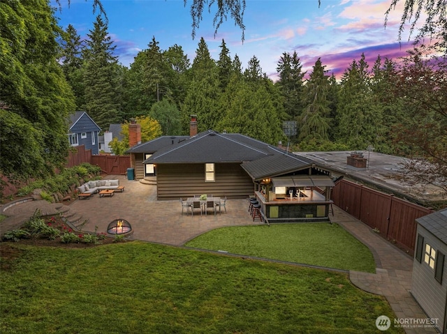 1309 NW Norcross Way, Seattle, WA 98177 - back of house at dusk featuring an outdoor living space with a fire pit, a patio, and a chimney