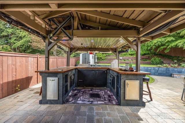 1309 NW Norcross Way, Seattle, WA 98177 - fenced backyard with an outdoor kitchen, a patio area, and a gazebo