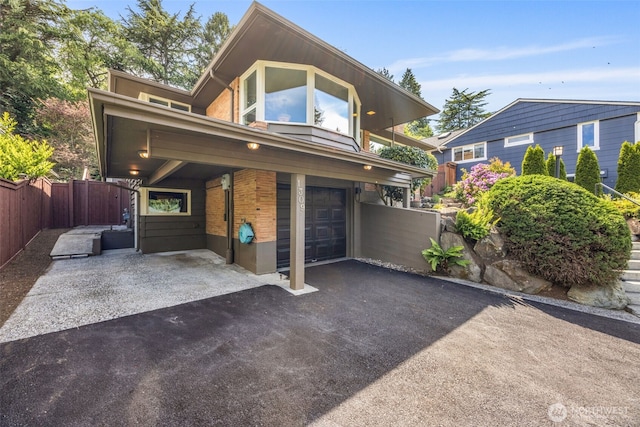 1309 NW Norcross Way, Seattle, WA 98177 - view of front of house featuring an attached garage, asphalt driveway, and brick siding