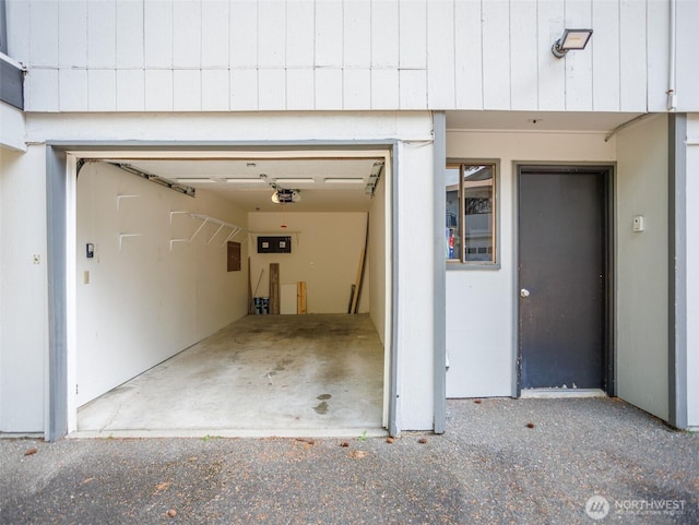 821 Essex Pl NE Unit 1-B, Lacey, WA 98516 - garage featuring electric panel and a garage door opener