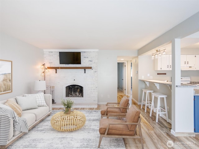 821 Essex Pl NE Unit 1-B, Lacey, WA 98516 - living room with light wood finished floors, a large fireplace, and baseboards