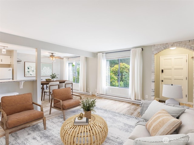 821 Essex Pl NE Unit 1-B, Lacey, WA 98516 - living area featuring light wood-style floors, a ceiling fan, and a baseboard heating unit
