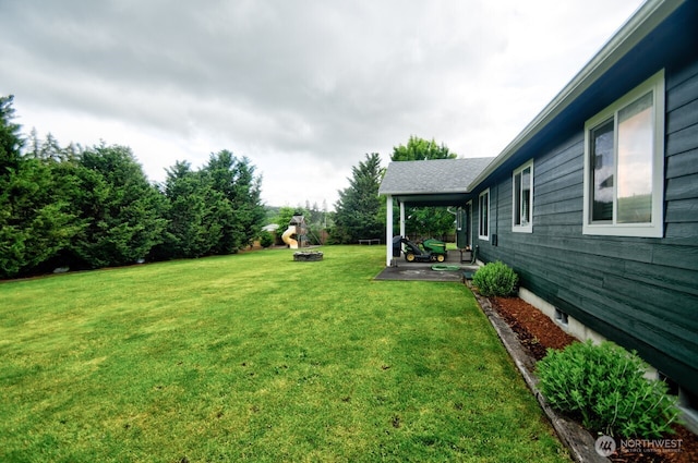17639 Dusty Ct SW, Tenino, WA 98589 - view of grassy yard featuring a patio and an outdoor fire pit