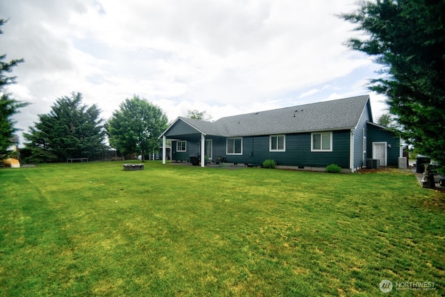 17639 Dusty Ct SW, Tenino, WA 98589 - rear view of house featuring a fire pit, central AC, a lawn, and roof with shingles