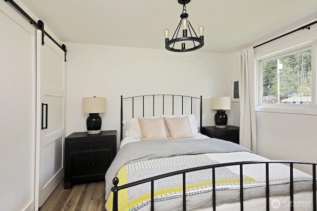 3596 Shell St, Greenbank, WA 98253 - bedroom with a barn door, a chandelier, and wood finished floors