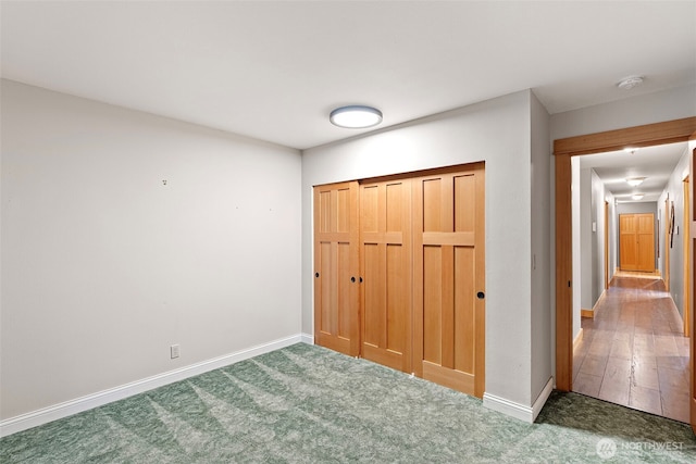 20460 Noll Rd NE, Poulsbo, WA 98370 - unfurnished bedroom with baseboards, carpet, and a closet