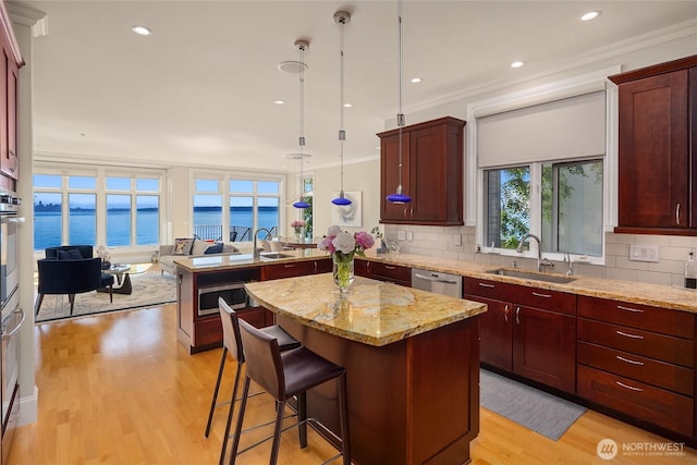 4864 Rockaway Beach Rd NE, Bainbridge Island, WA 98110 - kitchen featuring a sink, a peninsula, open floor plan, decorative backsplash, and ornamental molding