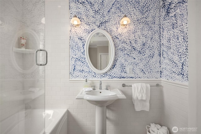 4864 Rockaway Beach Rd NE, Bainbridge Island, WA 98110 - bathroom with wallpapered walls, wainscoting, tile walls, and shower / bath combination with glass door