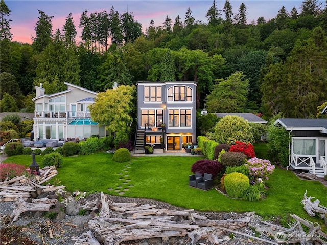 4864 Rockaway Beach Rd NE, Bainbridge Island, WA 98110 - back of property at dusk with a yard and stairway
