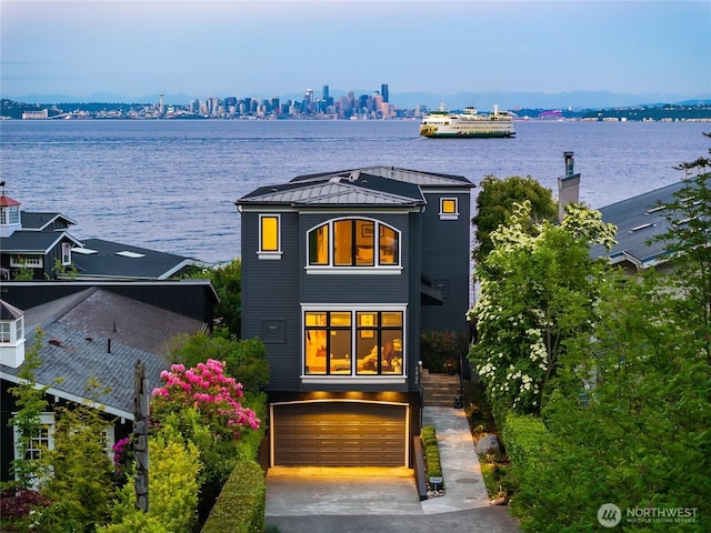 4864 Rockaway Beach Rd NE, Bainbridge Island, WA 98110 - view of front of property featuring a standing seam roof, metal roof, a water view, and a garage