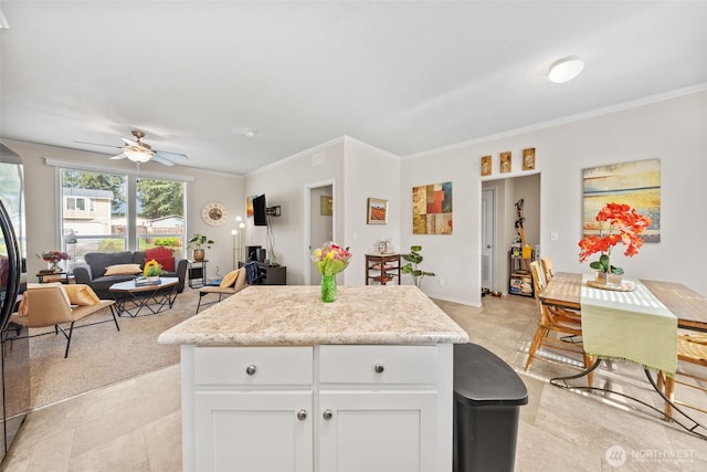 20318 E 67th Ave E, Spanaway, WA 98387 - kitchen featuring ornamental molding, ceiling fan, white cabinetry, a center island, and open floor plan