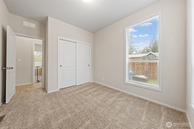 20318 E 67th Ave E, Spanaway, WA 98387 - unfurnished bedroom with light carpet, a closet, and baseboards