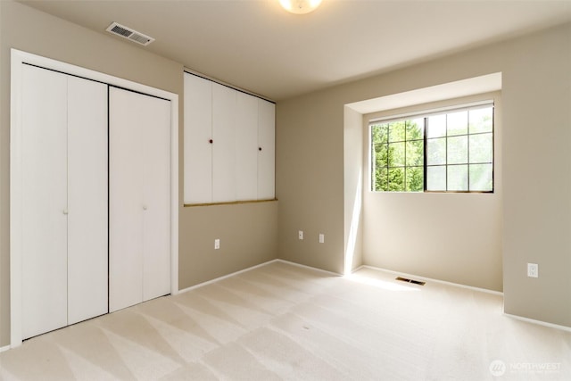 11633 132nd Ct NE, Redmond, WA 98052 - unfurnished bedroom with light colored carpet, baseboards, and a closet