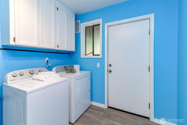11633 132nd Ct NE, Redmond, WA 98052 - laundry area with cabinet space, washer and clothes dryer, light wood finished floors, and baseboards