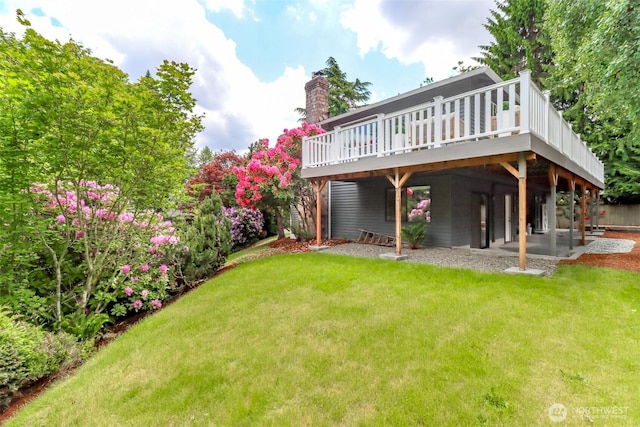 11633 132nd Ct NE, Redmond, WA 98052 - rear view of house with a wooden deck, a lawn, and a chimney