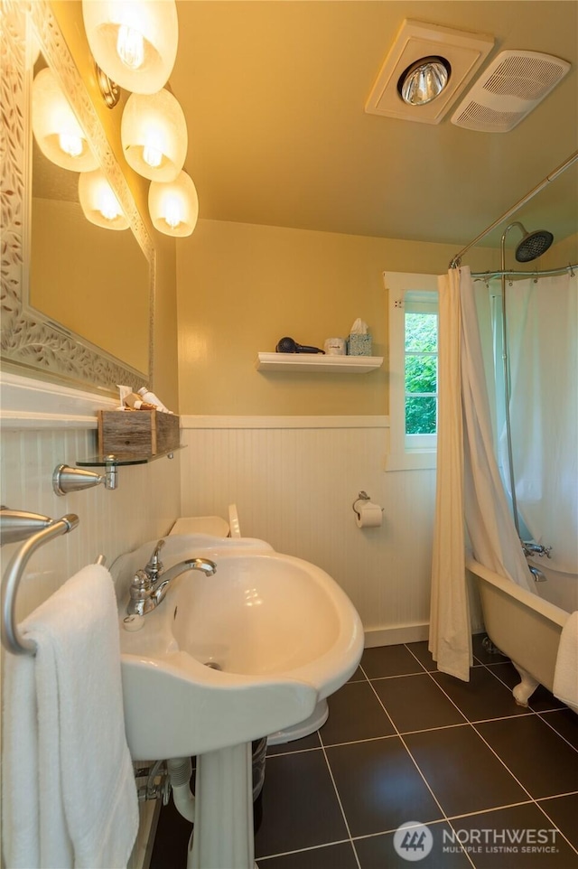 2579 W Shore Dr, Lummi Island, WA 98262 - bathroom featuring a wainscoted wall, tile patterned flooring, and shower / tub combo with curtain