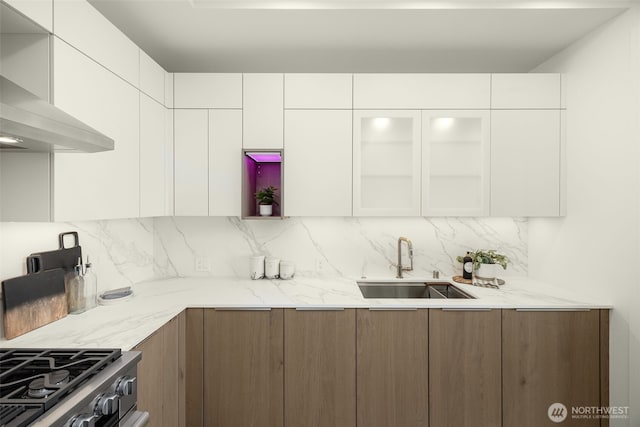999 110th Ave NE Unit 600, Bellevue, WA 98004 - kitchen with modern cabinets, a sink, wall chimney exhaust hood, backsplash, and white cabinetry