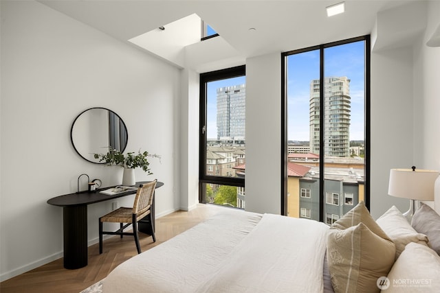 999 110th Ave NE Unit 600, Bellevue, WA 98004 - bedroom featuring a wall of windows, access to exterior, baseboards, and a view of city