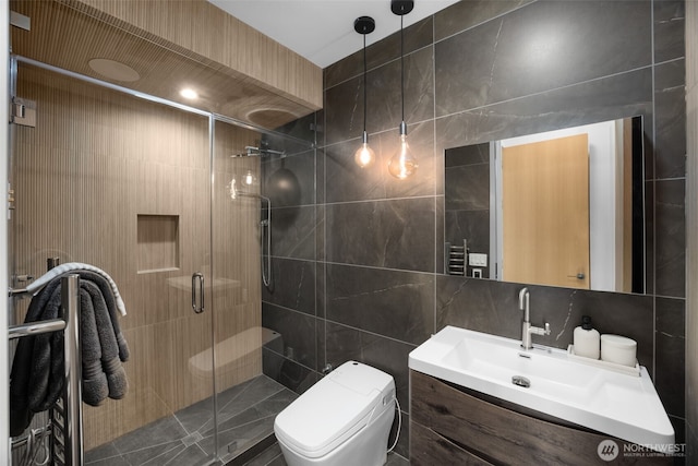 999 110th Ave NE Unit 600, Bellevue, WA 98004 - full bathroom featuring tile walls, toilet, vanity, and a shower stall