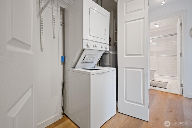 2524 Boyer Ave E Unit 108, Seattle, WA 98102 - washroom featuring stacked washing machine and dryer and light wood finished floors
