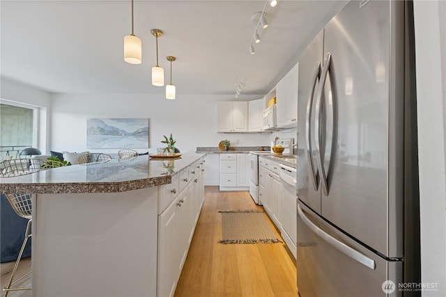 2524 Boyer Ave E Unit 108, Seattle, WA 98102 - kitchen with white appliances, light wood finished floors, white cabinetry, and pendant lighting
