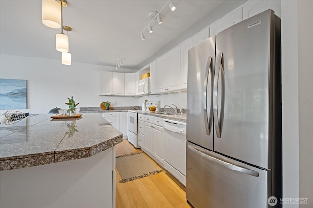 2524 Boyer Ave E Unit 108, Seattle, WA 98102 - kitchen with white appliances, tile countertops, white cabinets, light wood-style flooring, and a sink