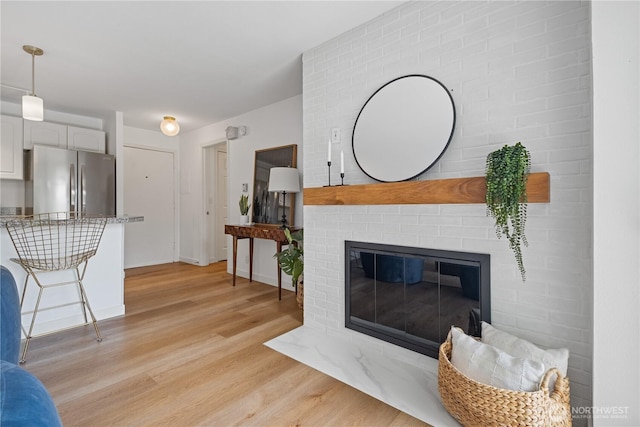2524 Boyer Ave E Unit 108, Seattle, WA 98102 - living area with light wood-type flooring and a brick fireplace