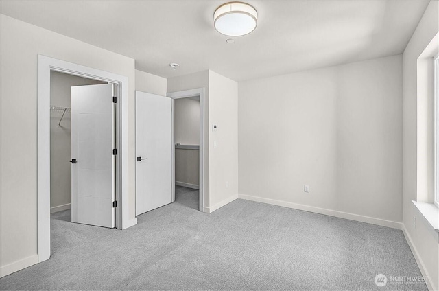 8922 NE 173rd Pl Unit A, Bothell, WA 98011 - unfurnished bedroom with carpet flooring, a walk in closet, and a closet