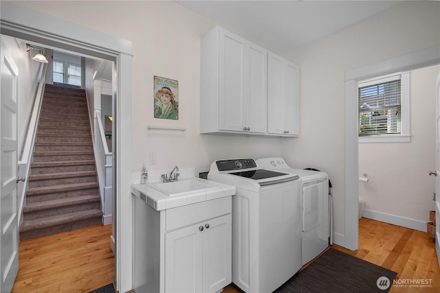 34 Seastar Ln, Pacific Beach, WA 98571 - laundry room featuring washing machine and clothes dryer, light wood finished floors, plenty of natural light, and baseboards