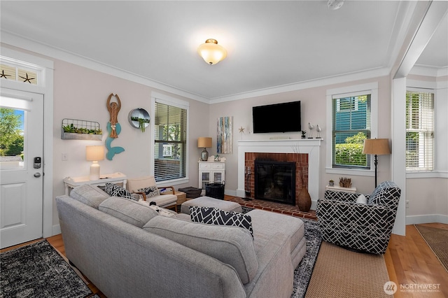 34 Seastar Ln, Pacific Beach, WA 98571 - living area featuring a fireplace, light wood-style floors, plenty of natural light, crown molding, and baseboards