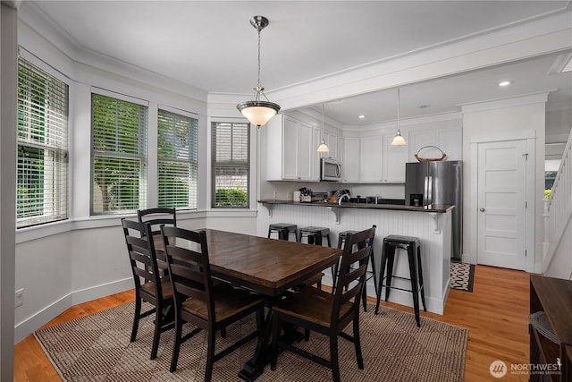 34 Seastar Ln, Pacific Beach, WA 98571 - dining space with healthy amount of natural light, light wood-style floors, ornamental molding, and baseboards