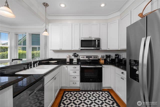 34 Seastar Ln, Pacific Beach, WA 98571 - kitchen with appliances with stainless steel finishes, a sink, light wood-style flooring, white cabinetry, and ornamental molding