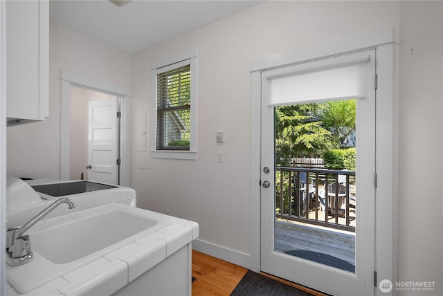 34 Seastar Ln, Pacific Beach, WA 98571 - laundry room with plenty of natural light, cabinet space, light wood-style flooring, and baseboards