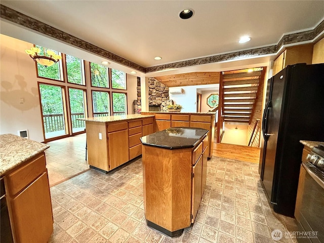 10802 NE 27th Ct, Vancouver, WA 98686 - kitchen with a kitchen island, a peninsula, recessed lighting, gas range, and light stone counters