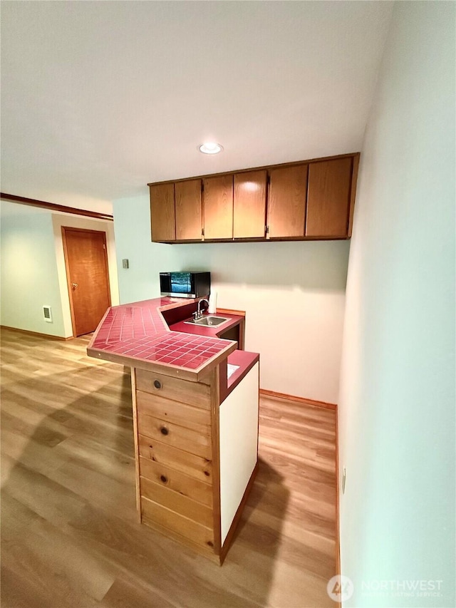 10802 NE 27th Ct, Vancouver, WA 98686 - kitchen featuring tile countertops, a sink, light wood-style floors, an office area, and recessed lighting