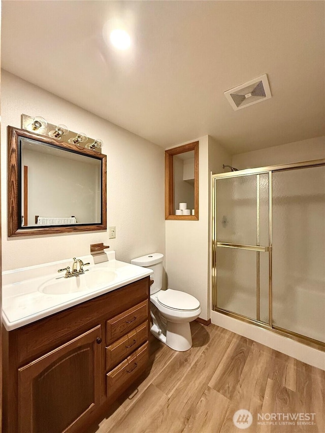 10802 NE 27th Ct, Vancouver, WA 98686 - full bath with wood finished floors, vanity, a stall shower, and toilet