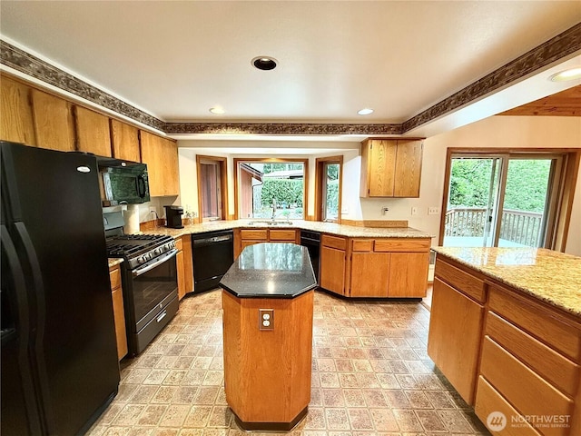 10802 NE 27th Ct, Vancouver, WA 98686 - kitchen featuring black appliances, a sink, a center island, brown cabinets, and recessed lighting