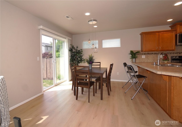 26133 242nd Ave SE, Maple Valley, WA 98038 - dining area with light wood-style flooring, baseboards, and recessed lighting