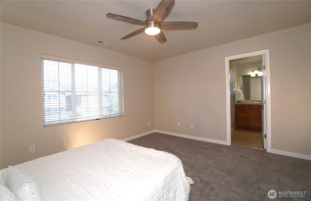 26133 242nd Ave SE, Maple Valley, WA 98038 - bedroom with dark colored carpet, baseboards, ceiling fan, and connected bathroom