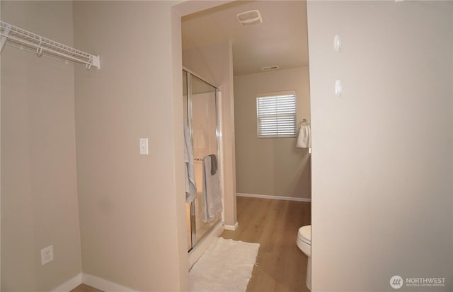 26133 242nd Ave SE, Maple Valley, WA 98038 - full bathroom featuring a shower stall, wood finished floors, baseboards, and toilet