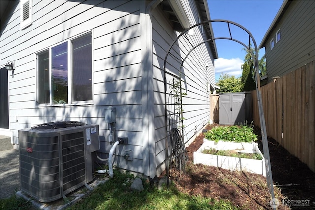 26133 242nd Ave SE, Maple Valley, WA 98038 - view of property exterior with central AC and a garden