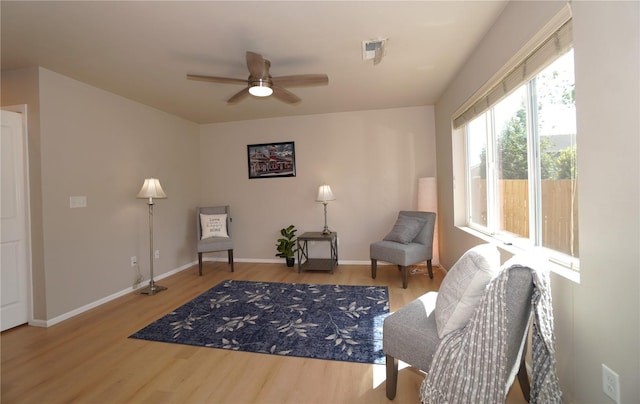 26133 242nd Ave SE, Maple Valley, WA 98038 - sitting room featuring wood finished floors, a ceiling fan, and baseboards