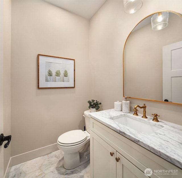 11407 73rd Ave NE, Arlington, WA 98223 - half bathroom with marble look tile flooring, vanity, toilet, and baseboards