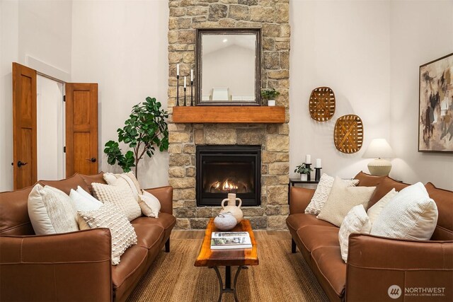 11407 73rd Ave NE, Arlington, WA 98223 - living room featuring a stone fireplace, wood finished floors, and a high ceiling